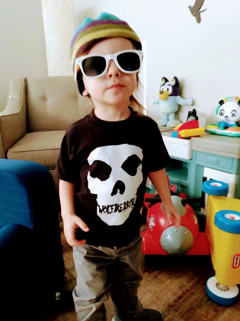 A very cool toddler wearing a WolfMerrik branded Print On Demand T-Shirt